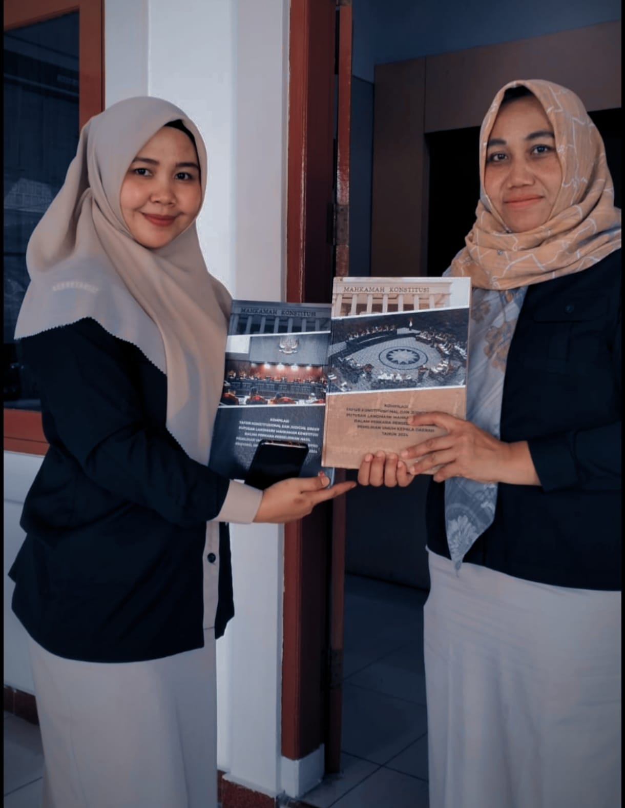 Penerimaan Buku "Landmark" Putusan MK sebagai Pedoman Sengketa Pilkada oleh staf Humas Bawaslu Padang Pariaman